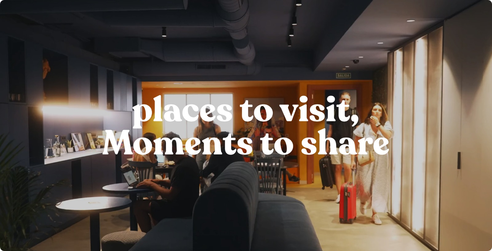 Guests arriving and socializing in a Coeo hostel lounge beneath the words ‘places to visit, moments to share’